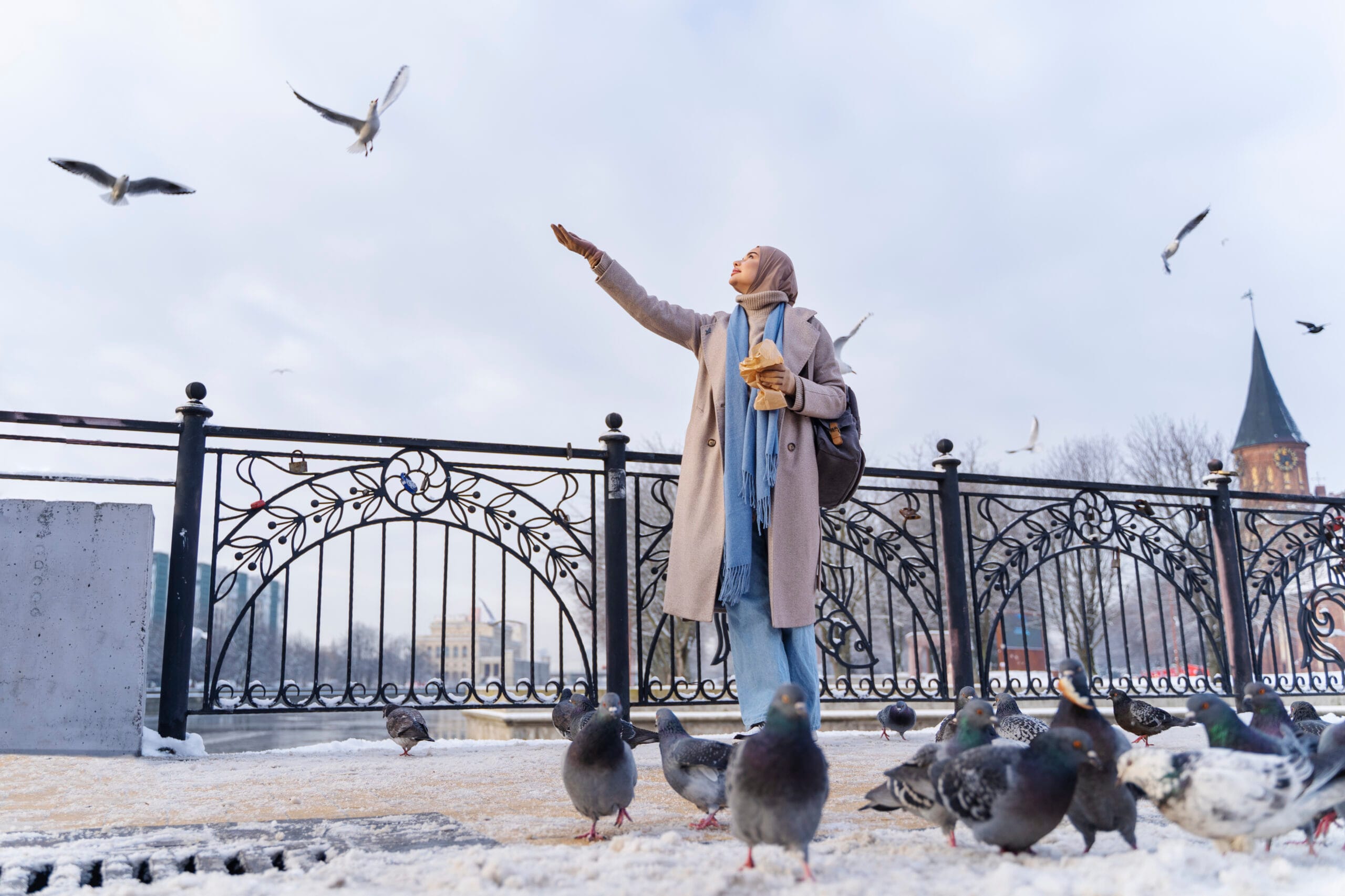 muslim-woman-feeding-pigeons-while-traveling-city muslim-woman-feeding-pigeons-while-traveling-city